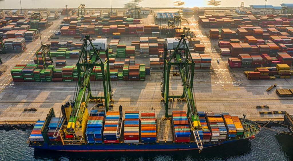 Aerial shot of colorful shipping containers at North Jakarta's bustling port, Indonesia.
